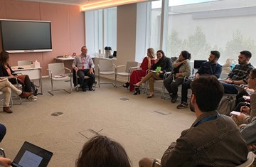 A group of people sitting together in a circle and having a discussion in Aga Khan Centre classroom